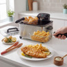 Stainless steel deep fryer with basket of chips and fish, UK kitchen setting