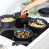 Set of blue non-stick saucepans and frying pans on hob with detachable handle