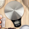 Salter digital kitchen scale with silver platform, shown on a wooden worktop