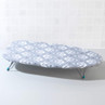 Small grey ironing board with white pattern, low folding legs