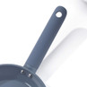 Non-stick blue frying pan showing textured handle and part of pan from above