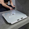 White digital bathroom scale with metal pads on concrete surface