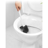 Black silicone toilet brush cleaning white ceramic toilet bowl