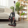 Cordless stick vacuum cleaner in a modern living room, shown upright on wooden floor