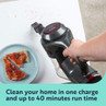 Cordless handheld vacuum cleaning crumbs from a table beside toast