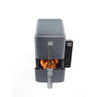 Grey dual drawer air fryer with cooked chicken in lower basket, digital display lit up