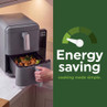 Grey air fryer with food drawer open and energy saving message