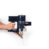 Handheld cordless vacuum in navy, showing easy empty dustbin feature over a white background