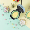 Light blue waffle maker creates Easter egg-shaped waffle, with sweets and marshmallows shown