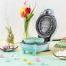 Light blue Easter egg waffle maker with waffle inside, spring decor and sweets