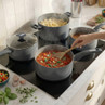 Set of grey non-stick saucepans in use on hob, ideal for cooking pasta and sauces