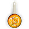 Cream saucepan filled with butternut squash soup, garnished with cream, herbs and chilli flakes