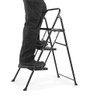 Black 3-step folding ladder with person standing, shown for size and use context