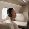 Black over-ear wireless headphones worn on flight
