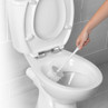 Toilet brush cleaning white ceramic toilet in tiled bathroom