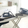 Beldray Steam Surge Pro dark blue steam generator iron on an ironing board