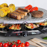 Granite raclette grill with sausages, burger, corn and peppers, mini pans with omelette