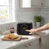 Black digital toaster with touchscreen controls on kitchen counter
