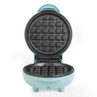 Open mint green mini waffle maker shown from front, empty and ready to use