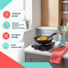 Portable black electric hob cooking noodles, with 1500W power and adjustable heat