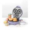 Purple mini donut maker open with freshly baked donuts and decorated donuts nearby