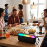 Black wireless portable speaker with multicolour LED lights, placed on social gathering table