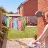 Retractable washing line with laundry drying in a sunny UK garden