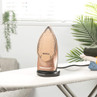 Rose gold Beldray steam iron upright on ironing board with folded clothes