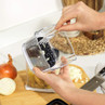 Manual onion chopper in use on kitchen worktop with chopped onions shown