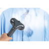 Handheld garment steamer removing wrinkles from light blue shirt