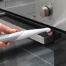Electric cleaning brush cleaning oven door handle