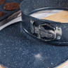 Round blue speckled springform cake tin with silver latch, close-up