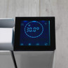 Close-up of white digital radiator with illuminated control panel display