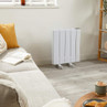 White portable electric radiator in modern living room, shown against wall on wheels.
