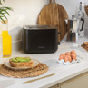 Black Salter toaster on kitchen counter with eggs and avocado toast