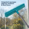 Turquoise squeegee mop with integrated edge cleaning water from window.