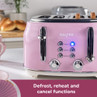 Pink four-slice toaster with defrost, reheat and cancel functions shown on kitchen counter