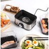 Salter stainless steel sous vide cooker with dial, shown with eggs, salmon and salad.