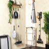 Cleaning supplies and tools organised in utility room, including mop, broom, vacuum, and drying rack.