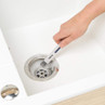 Hand cleaning a sink drain with a small brush