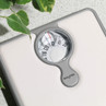 White mechanical bathroom scale with Salter branding, shown on countertop.