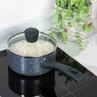 Black speckled saucepan with glass lid containing cooked rice on induction hob