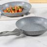 Grey non-stick frying pan with speckled finish, shown on kitchen surface