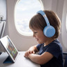 Child wearing light blue headphones watching a cartoon on a tablet during flight