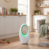 White bladeless fan with green light, freestanding in modern kitchen-living space