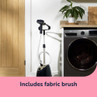 Garment steamer beside washing machine with fabric brush attachment