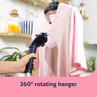 Pink V-neck top being steamed on hanger