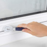 Cleaning brush with blue handle used to clean white window track