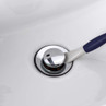 Chrome bathroom sink plug shown with blue and white handle for removal
