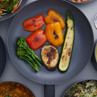Frying pan with grilled red and yellow peppers, courgette, aubergine and tenderstem broccoli